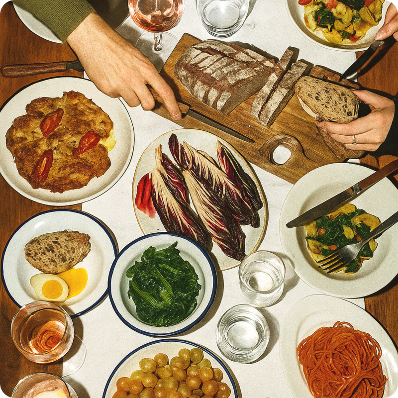 Overhead view of a table full of colorful food dishes and drinks